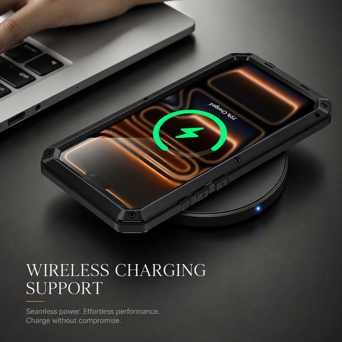 A black rugged phone rests screen-up on a circular wireless charging pad beside a laptop. A bright green charging ring appears on its screen.