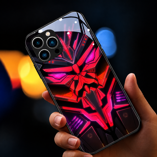 A hand holds a glossy black case with a bright red and magenta stylized robotic mask against blurred colored lights.