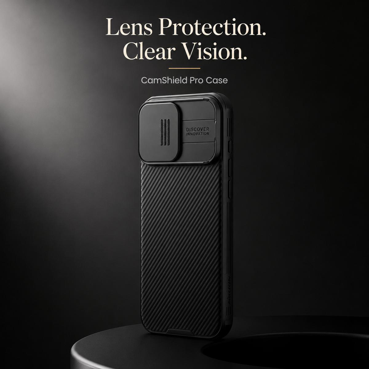 A black ribbed case stands on a round dark platform with its camera cover closed beneath Lens Protection. Clear Vision.
