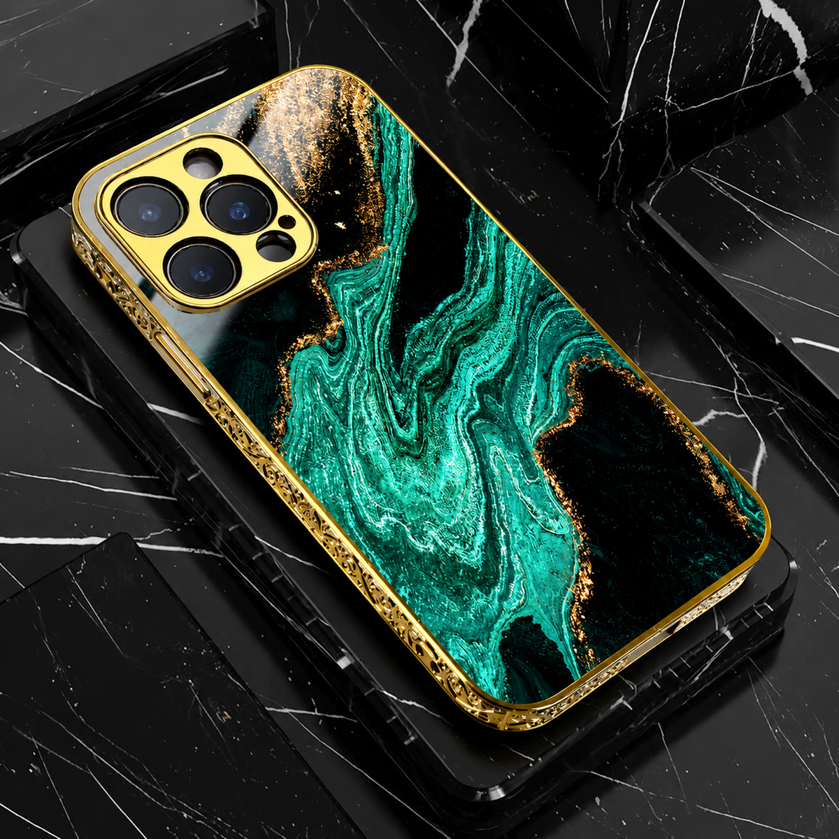 A teal and black marble-pattern phone case lies on black blocks. Turquoise bands curve through black areas with gold-colored accents, surrounded by ornate gold-colored edging.