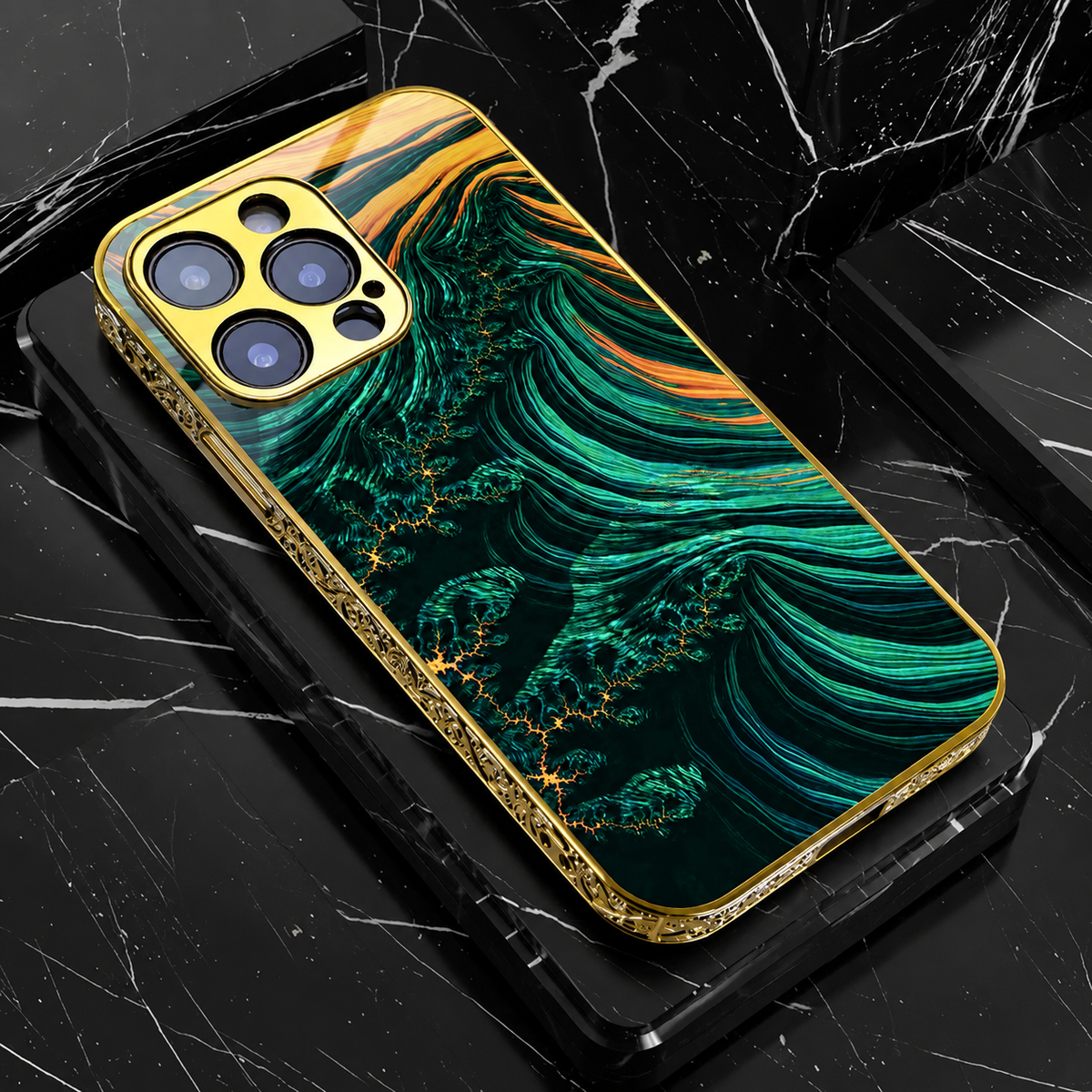 A dark green phone case lies on black blocks, showing fine sweeping teal and gold-colored bands across its back. Ornate gold-colored edges frame the pattern and camera surround.