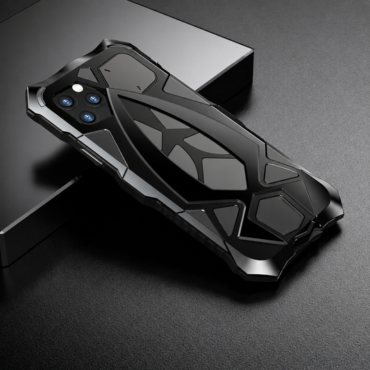 A black armor-style case rests diagonally across a dark display block, showing geometric rear layers and angular corner guards.