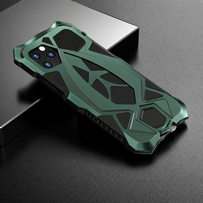 A green-and-black armor-style case rests across a dark block, with raised geometric rear sections and angular corners.