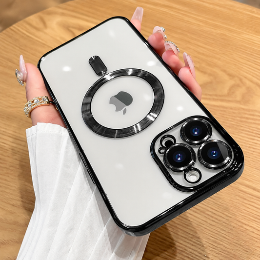 A hand holds a white-backed phone case upside down above a wooden table, showing glossy black edges, separate lens rims and a circular rear ring.