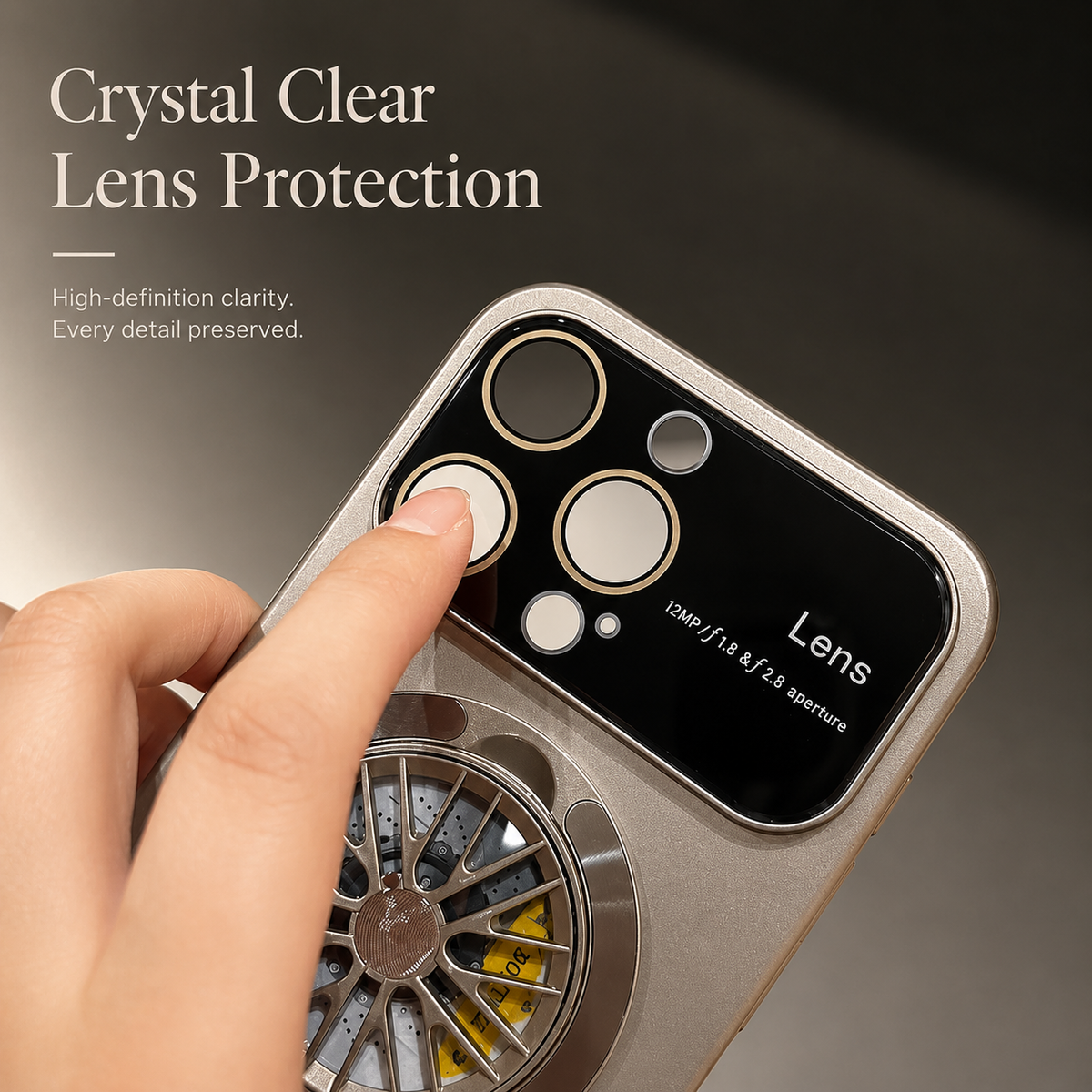 A finger touches a circular camera opening in the broad glossy panel of a gray case beneath Crystal Clear Lens Protection.