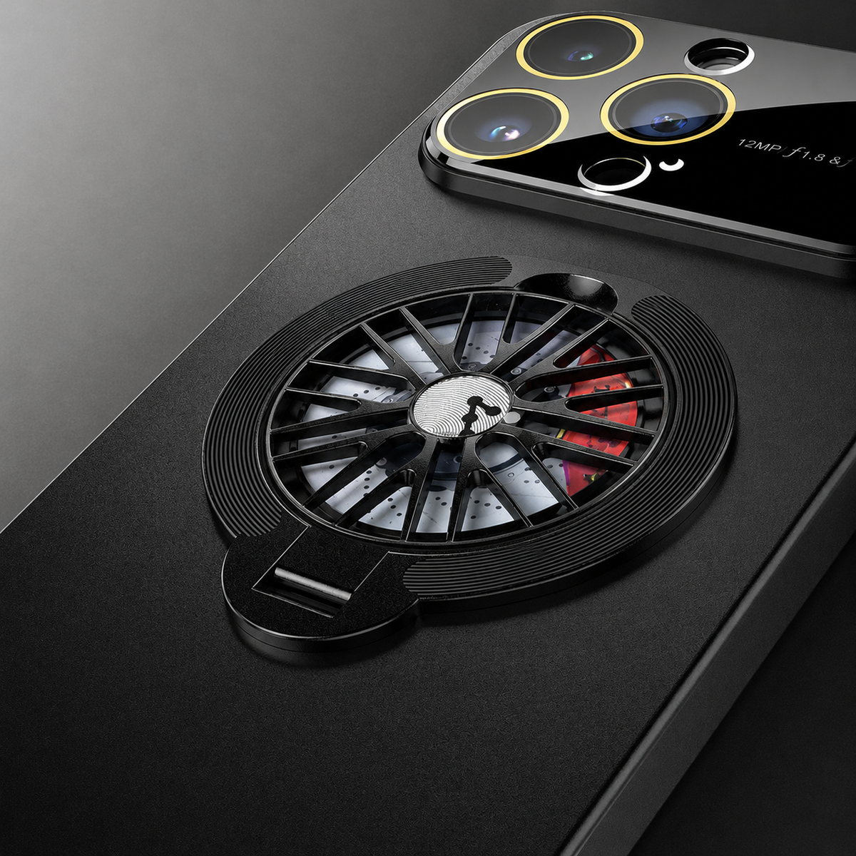 A close-up shows the black circular rear ring with silver spokes and red accents, plus the glossy camera panel above.