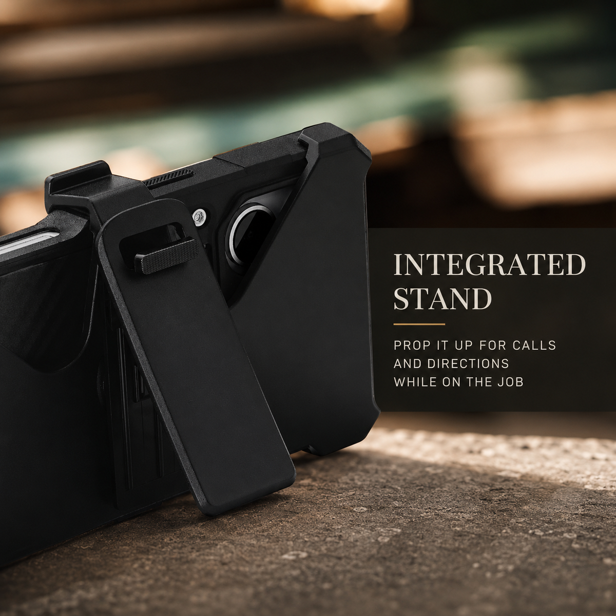 A rugged black case rests horizontally on a wide extended clip that acts as a stand on brown rock. A softly blurred warm background frames the heading Integrated Stand.