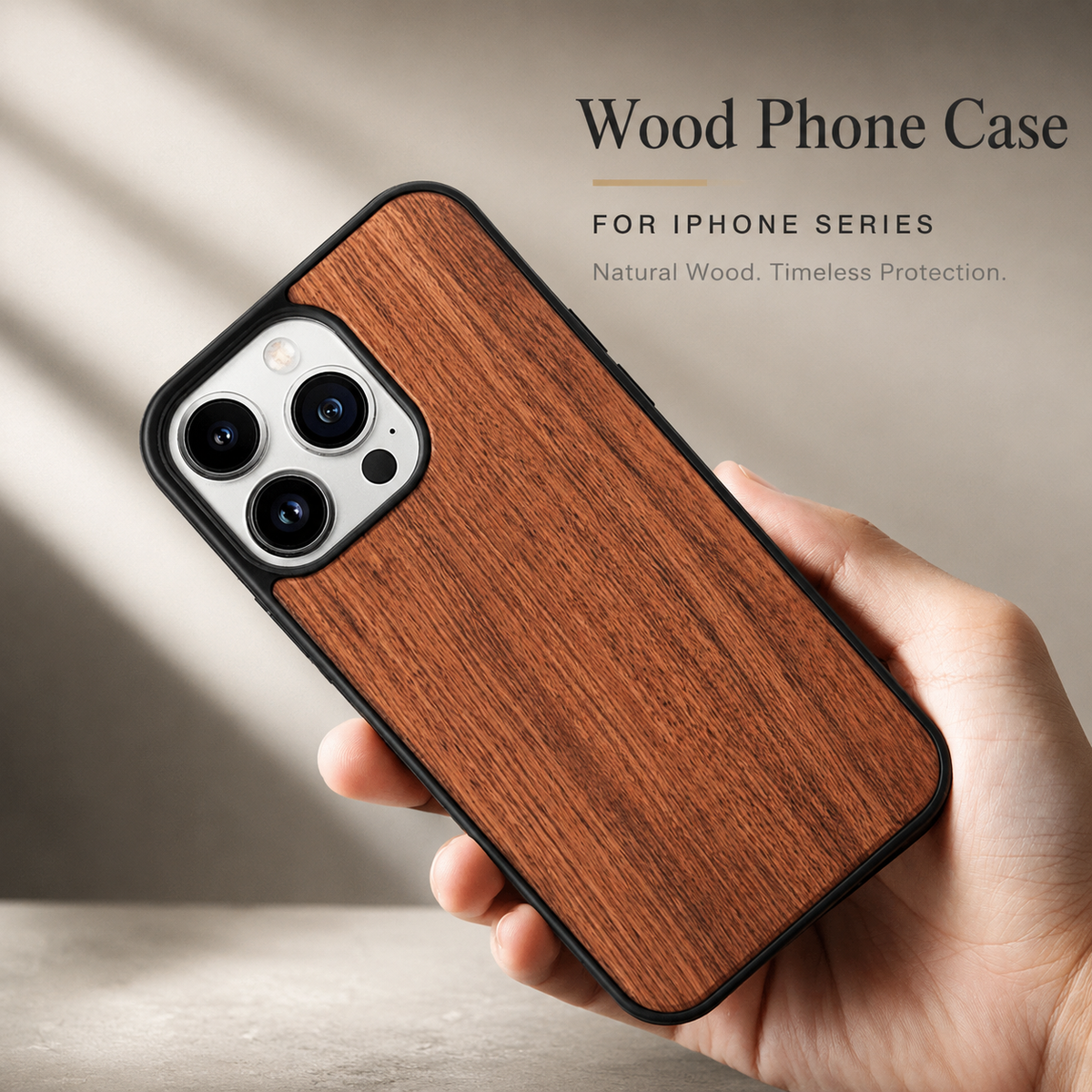 A hand holds a warm reddish-brown wood-backed phone diagonally against a softly blurred beige background. The thumb rests along one black edge, and the fingers support the opposite side. Three rear camera lenses sit within a pale opening at the upper end. Text above reads 'Wood Phone Case' and 'For iPhone Series.'