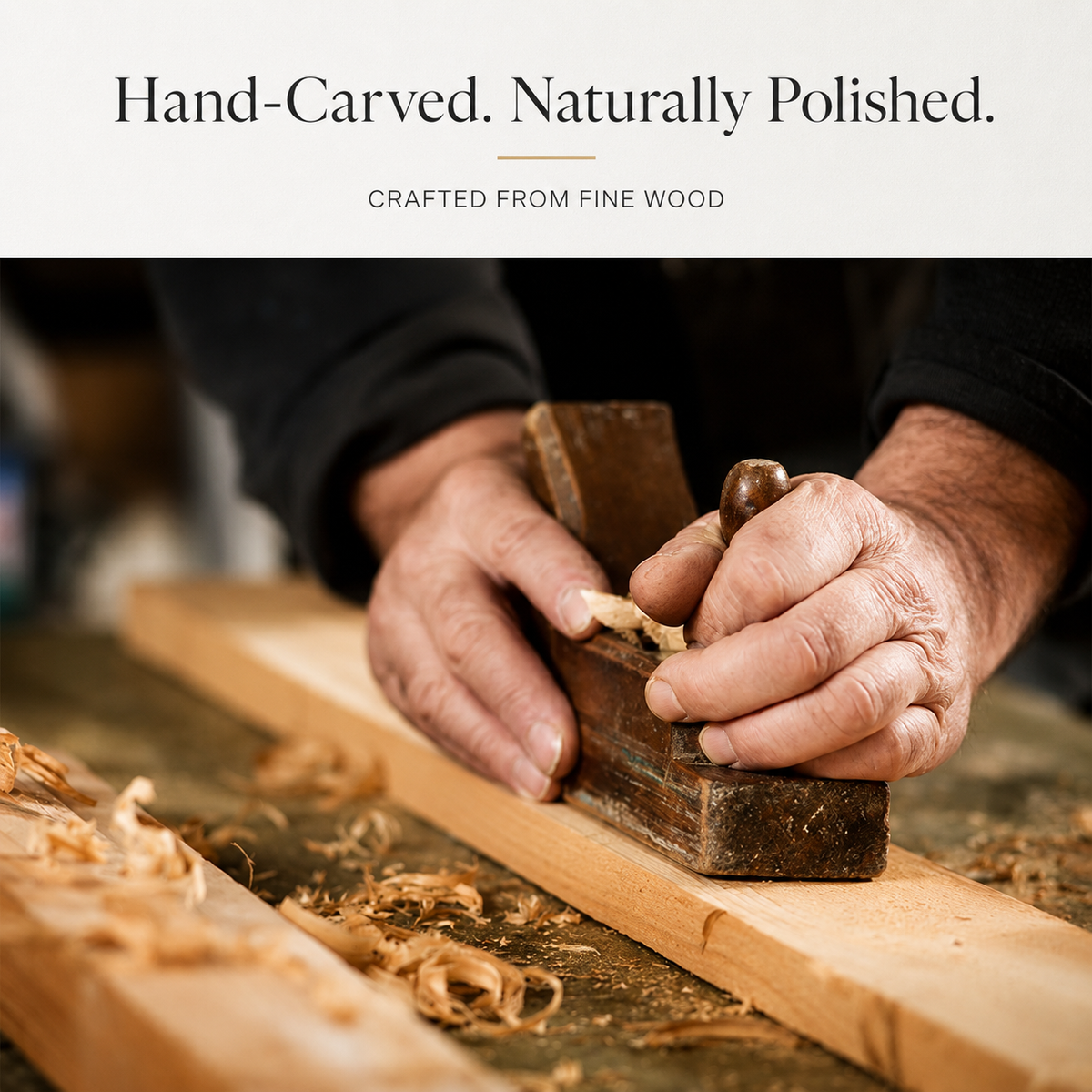 A cropped photograph shows a person's hands using a wooden hand plane on a long board at a workbench scattered with curled wood shavings. The person wears dark sleeves, and the tool is pressed along the board's grain. Above the photograph, a pale banner reads 'Hand-Carved. Naturally Polished,' followed by 'Crafted From Fine Wood.'