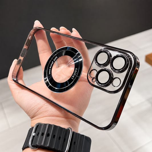 A hand with a black watch holds a clear phone case horizontally indoors, showing black reflective edging, separate round camera openings and a large black-and-silver circular magnetic mark.