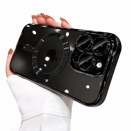 A hand in a white sleeve holds a glossy black-tinted clear phone case horizontally against white. A reflective circular magnetic marking surrounds the visible Apple logo, with a short alignment bar below. Reflective raised borders outline the three camera lenses. Small ceiling-light reflections dot the back.