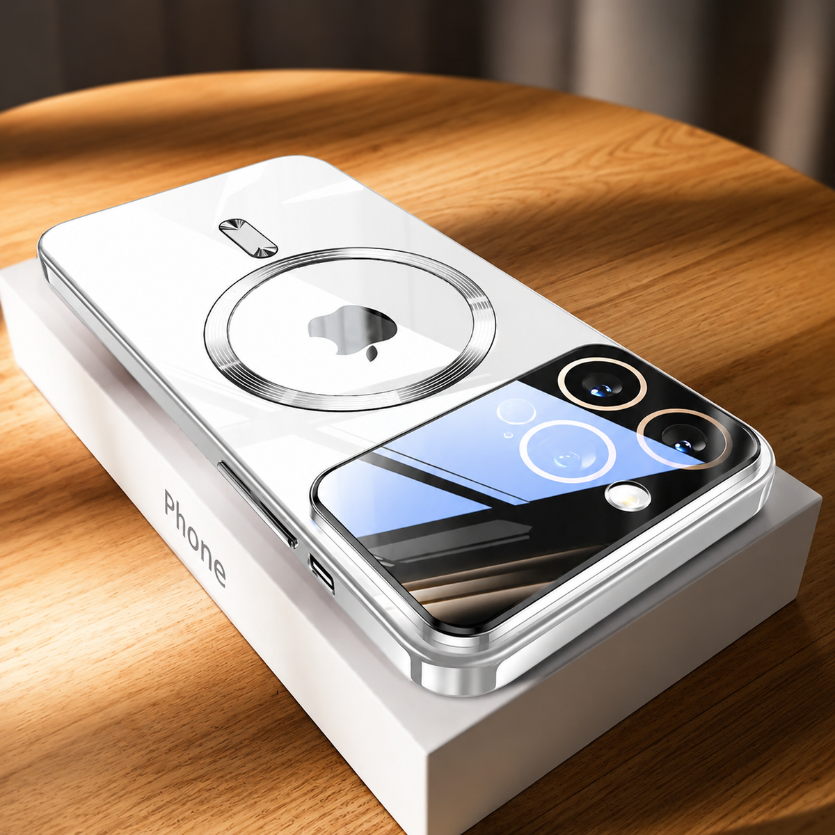 A highly reflective clear-backed phone case with silver edges lies diagonally on a white phone box atop a wooden table. A circular magnetic marking surrounds the Apple logo, with a short bar below. Dark and blue window reflections cross the glossy surface and camera panel, while the side frame and charging cutouts remain visible.
