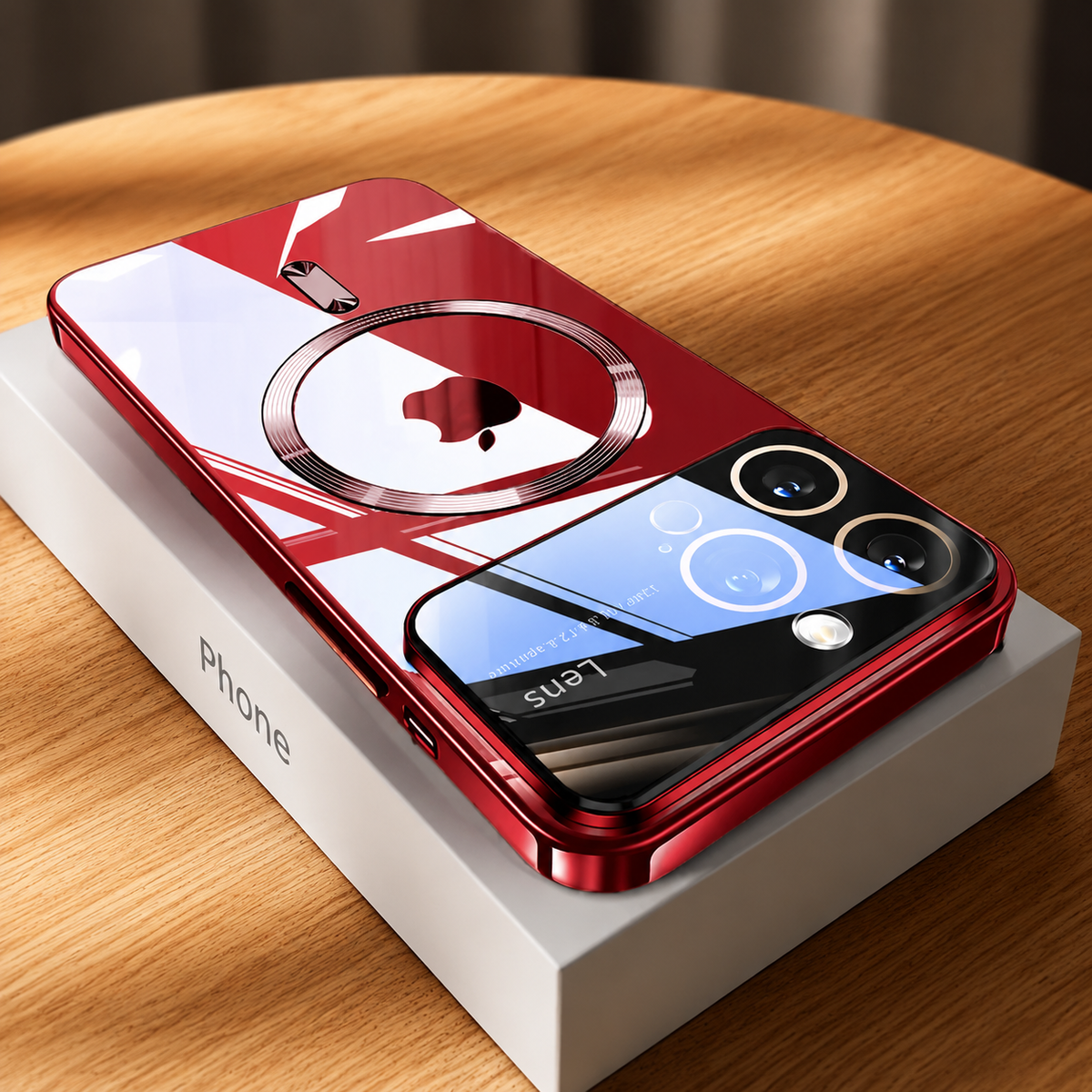 A highly reflective clear-backed phone case with red edges lies diagonally on a white phone box atop a wooden table. A circular magnetic marking surrounds the Apple logo, with a short bar below. Dark and blue window reflections cross the glossy surface and camera panel, while the side frame and charging cutouts remain visible.