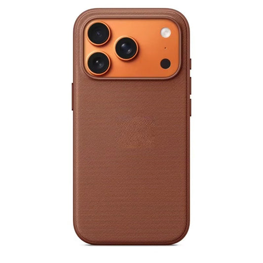 A brown fabric-textured phone case stands upright against a white background. Its plain woven back is bordered by a smooth brown bumper, with a wide orange camera panel at the top containing three black lenses, a pale flash, and a small dark opening. Covered buttons project from the sides.