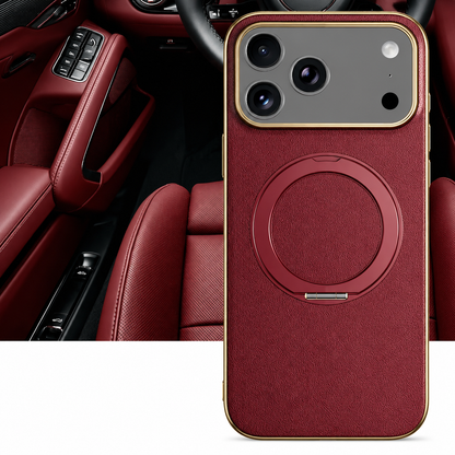 A burgundy textured case stands before a red car interior. Gold-colored edging surrounds its camera panel and matching circular folding ring.