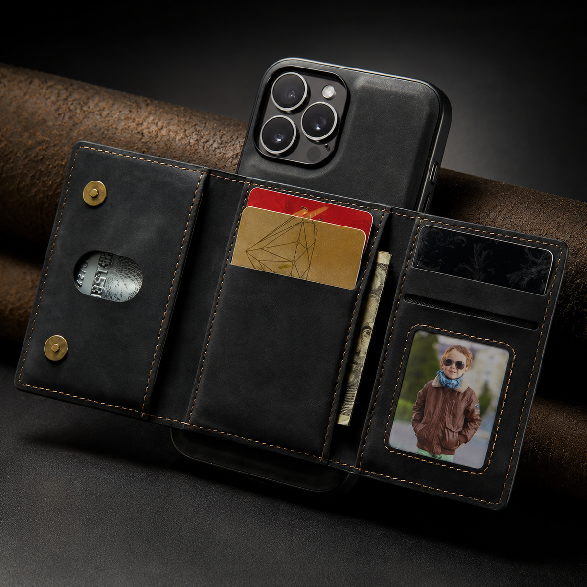 Black rear wallet opens into three panels beneath a square camera opening, showing colored cards, folded cash, a portrait ID window, and two round closure fasteners.