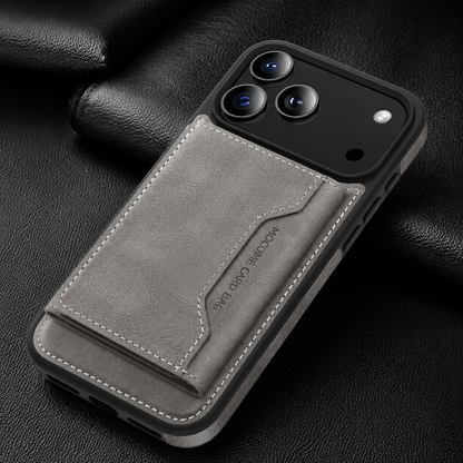 A gray wallet case lies diagonally on black fabric, showing its closed stitched rear flap.