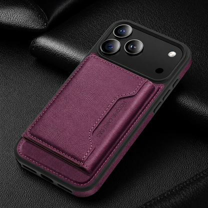 A burgundy wallet case lies diagonally on black fabric, with a matching rear flap below the camera panel.