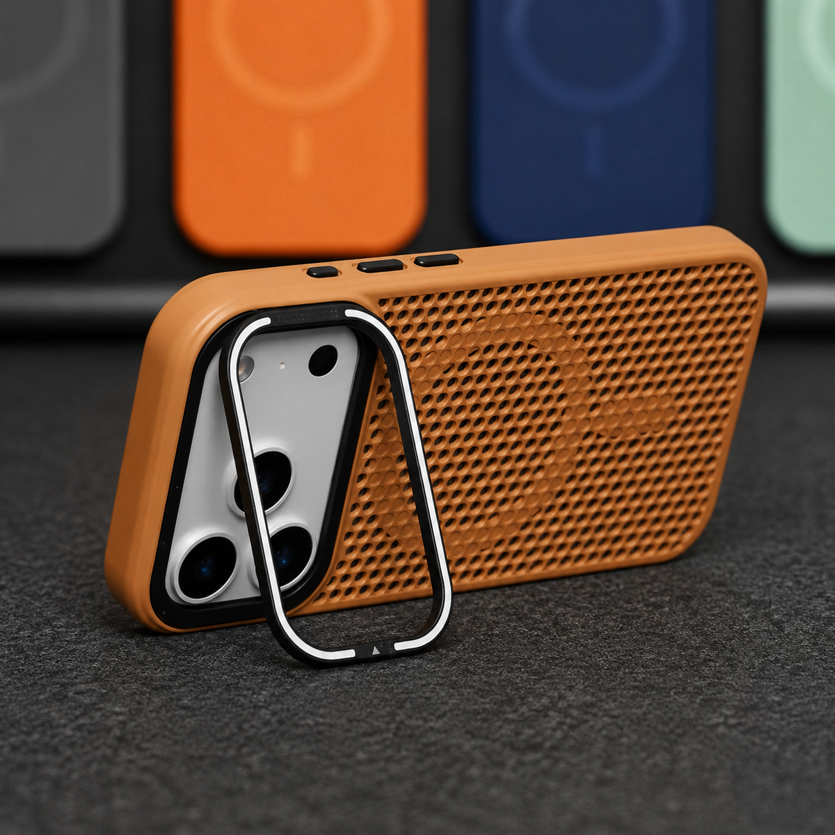 A tan perforated phone case stands horizontally on a rectangular camera-frame stand, showing its circular rear ring and small black side controls.