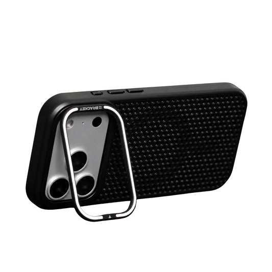 A black perforated phone case stands horizontally against white on a silver-edged rectangular stand hinged around its broad camera opening.
