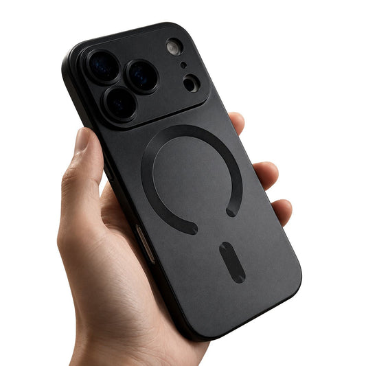 A hand holds a black phone case against white, with a wide camera guard and a dark horseshoe-shaped ring and short bar on the back.