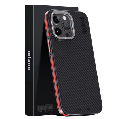 A black phone case with a diagonal weave pattern stands in front of a tall black retail box on a white background. Red accents line the exposed side buttons and border, contrasting with the silver-colored three-lens camera surround. The phone is angled slightly to reveal the back and sidewall.