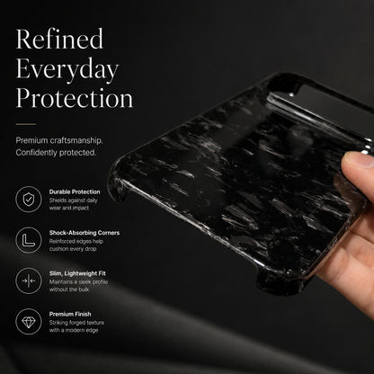 A hand tilts a glossy black shard-patterned case to reveal its bottom corners and open edge sections. Text advertises durable protection, shock-absorbing corners and a slim lightweight fit.