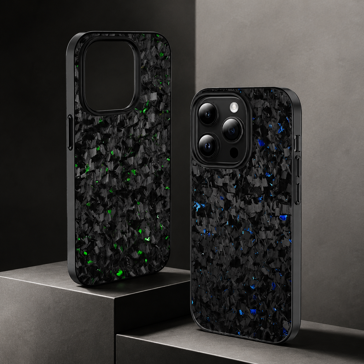 Green- and blue-flecked cases stand on stepped gray display blocks. One empty case shows its large camera opening; the other contains a phone with a dark camera panel.