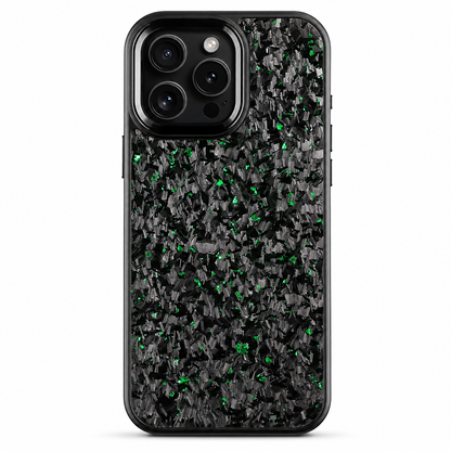 A black phone case stands upright on white. Irregular green flecks are scattered through a dark mottled pattern across the back. A smooth rounded black camera surround encloses three lenses, flash and sensor, and a narrow black rim outlines the case.