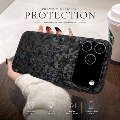 A hand in a white knit sleeve supports a blue-flecked black phone horizontally above a wooden café table. The back faces the viewer, with a large glossy camera panel at the right showing three lenses. A takeaway cup is partly visible behind it. The heading reads 'Premium Everyday Protection,' above four feature icons along the bottom.