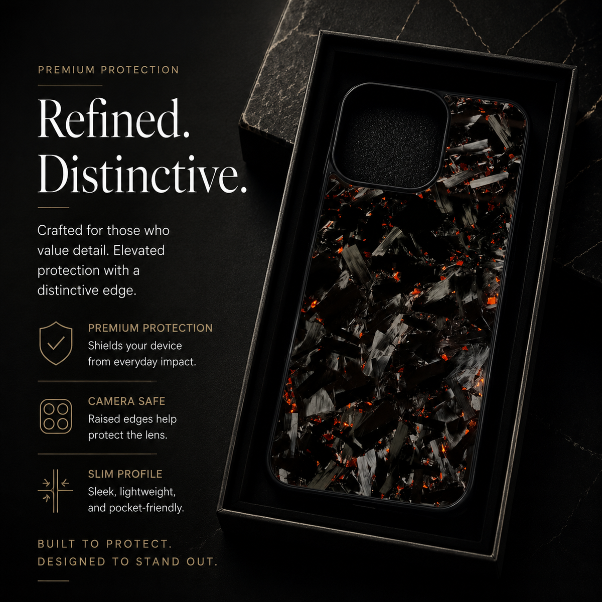 A black case with gray fragments and orange-red flecks rests inside a black presentation tray on a dark stone surface. Text highlights raised camera edges, protection and a slim profile.