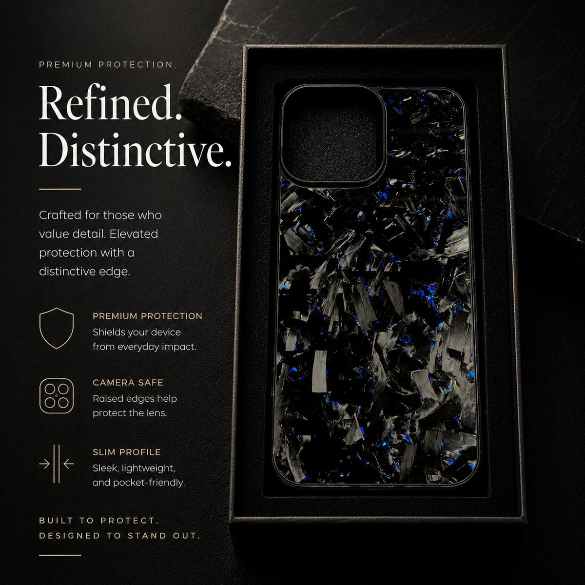 A black case with irregular gray fragments and blue flecks stands vertically inside a black tray, beside text promoting protection and raised camera edges.