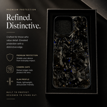 A glossy black case with silver-gray fragments and scattered yellow-gold flecks sits upright in a black presentation tray beside text promoting everyday protection.