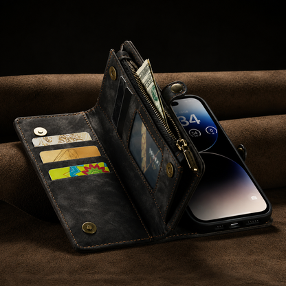 An open black wallet phone case rests on brown fabric, showing cards, banknotes, a clear window and side zipper, with the phone screen visible behind the folded organizer.