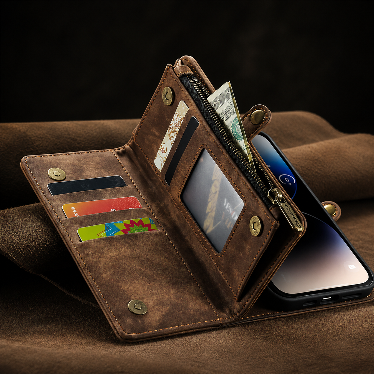 An open brown wallet phone case rests on brown fabric, displaying cards, banknotes, a clear window and zipper, with the phone screen visible behind it.