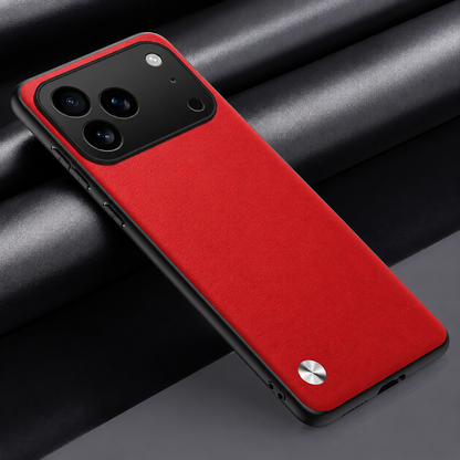Red textured phone case lying diagonally on dark fabric, with a black wide camera panel and a small silver circular accent.