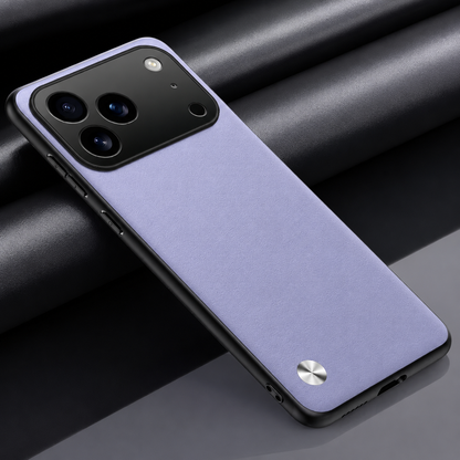 Lavender textured phone case on dark fabric, with black edging, a broad camera opening and a small silver circular accent near the bottom.