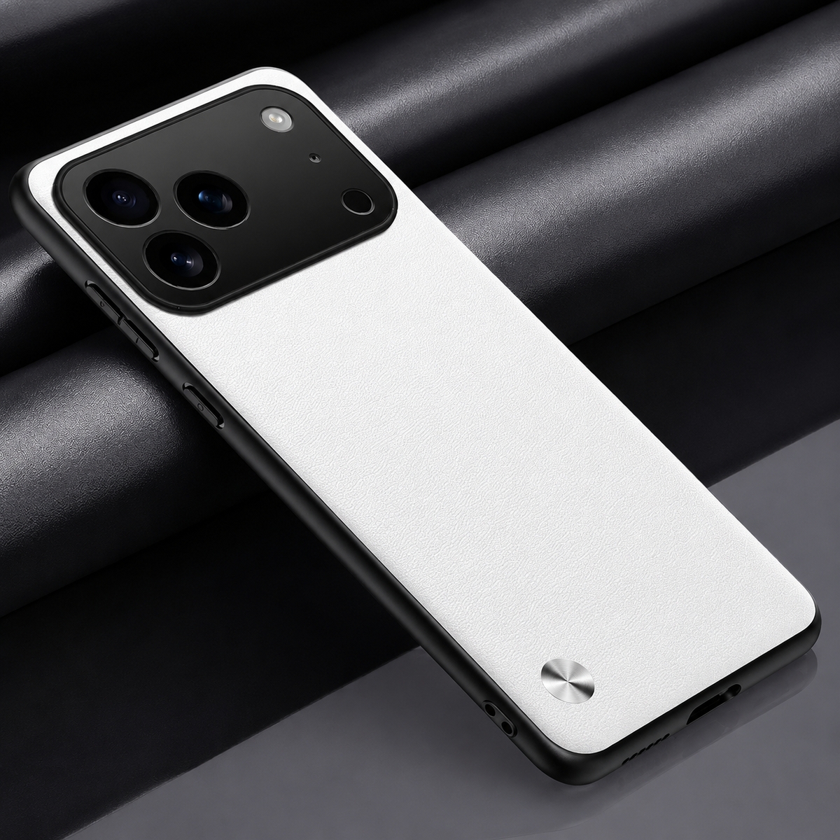White textured phone case lying diagonally on dark fabric, with black edging, a broad camera opening and small silver circular accent.