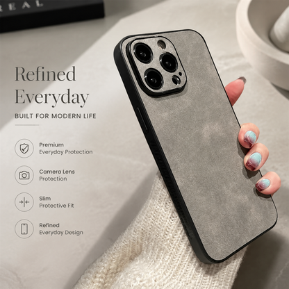 Hand holds a gray suede-look case diagonally, showing its mottled back, black edge, and matching camera panel beside text highlighting protection and a slim fit.