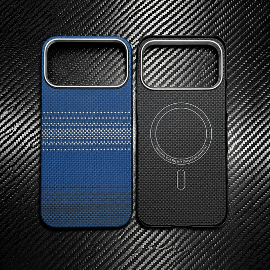 Two blue and black phone cases lie side by side on a black woven surface, showing the outer back and inner face. Each has a wide rectangular camera opening; a circular magnetic alignment marking appears inside.