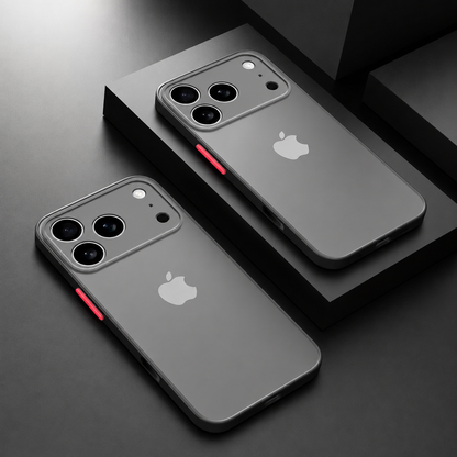 Two black-bordered translucent gray cases with red side buttons and square camera guards arranged on dark geometric blocks.