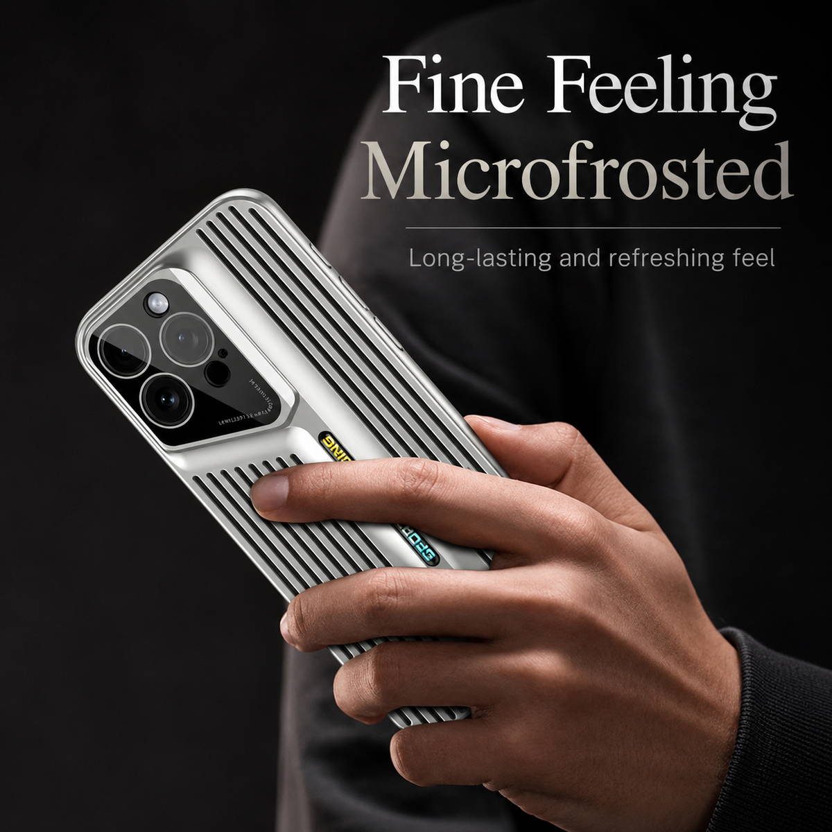 A hand holds a silver slotted case upright against black, with a finger resting across the patterned back. Text promotes a microfrosted feel.