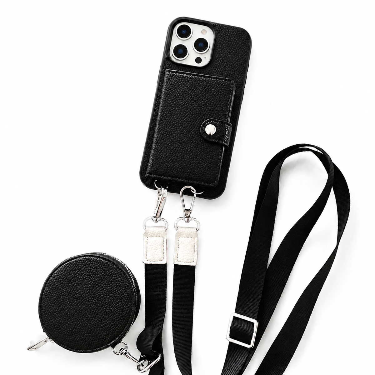 A black textured wallet phone case, matching round zippered pouch, and long black strap are arranged on a white background. A stitched rectangular card flap with a silver-colored snap covers the case's back. Two metal clips connect the strap ends to loops along the phone's lower edge, and an adjustment buckle sits on the strap.