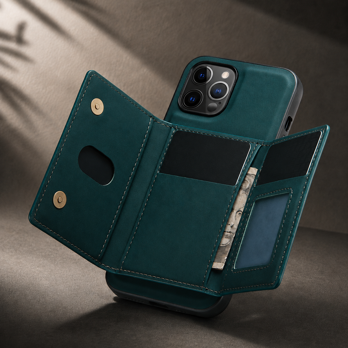 Teal wallet phone case opened into three panels, showing black card slots, folded cash, an empty ID window and gold-colored snaps in angled sunlight.