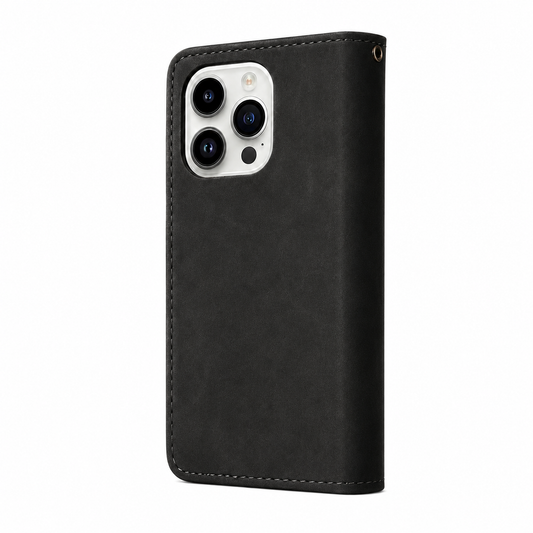 A black leather-look wallet phone case is shown from the back against white. Stitched edges border its subtly mottled surface, with a rectangular three-camera opening and a small gold-colored strap eyelet near the top.