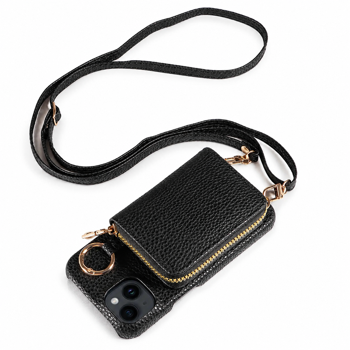 A black pebbled leather-look phone case lies on white with a matching long strap looped above it. A gold-colored zipper surrounds a rectangular wallet pouch on the back, beside a circular ring.