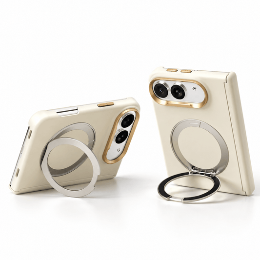 Two cream-colored phone cases with built-in metallic rings and gold camera trim, shown on a clean white background. One case is propped open to display the ring stand, and the other is shown from the back.
