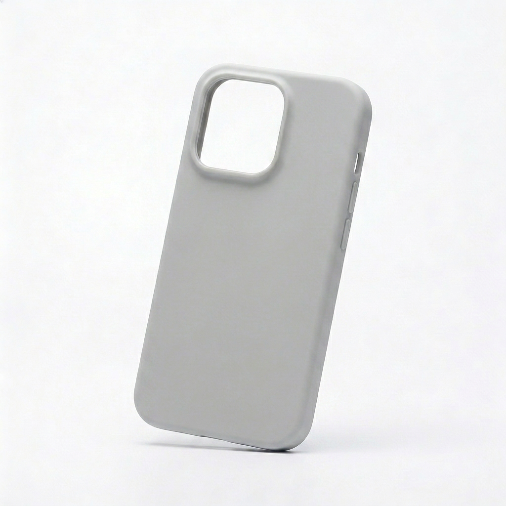 An empty light gray phone case leans at a slight angle against white. Its smooth plain back has a large raised rectangular camera opening at the upper left, while covered buttons and smaller openings are visible along the side.