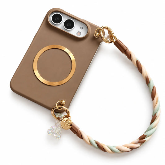 A brown phone case with a gold magnetic ring, attached to a braided wrist strap in brown, beige, and mint green, featuring gold hardware and a small charm, shown on a white background.