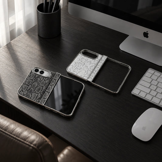 Two luxury phone cases with a textured crocodile pattern are displayed on a dark wooden desk next to an iMac, keyboard, and mouse.
